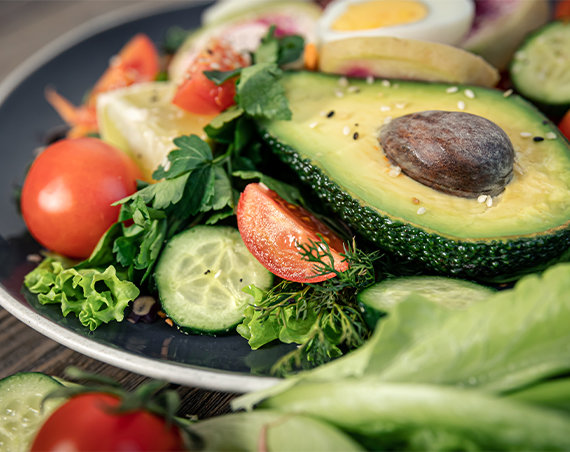 Plate of vegetables and healthy fats to allow participant to reach ketosis through weight loss program protocol.